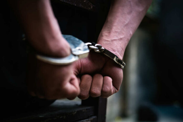 Man,On,The,Chair,In,Handcuffs.,Rear,View,And,Closeup