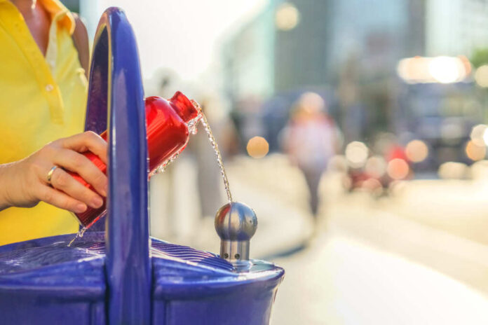 Traveler,Refills,A,Bottle,Of,Drinking,Water,.,Concept,-