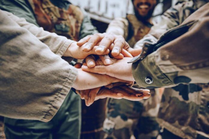 Soldier,,Team,Building,Or,Hands,In,A,Huddle,For,A