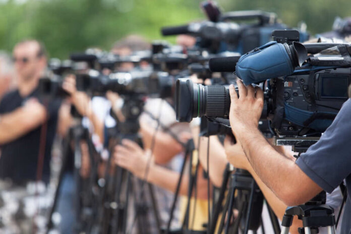 News,Conference.,Filming,An,Event,With,A,Video,Camera.