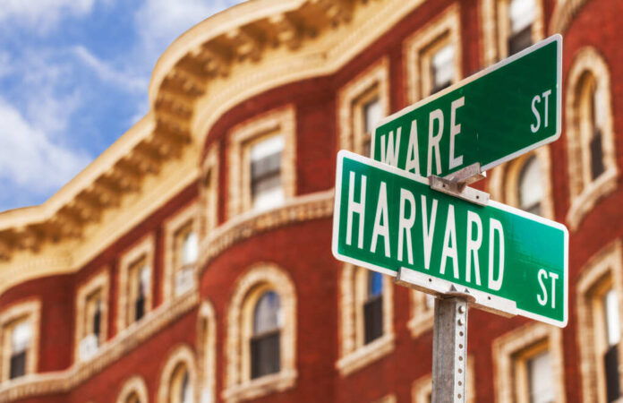 Harvard,Street,Sign,With,A,Classic,Red,Brick,Building,In