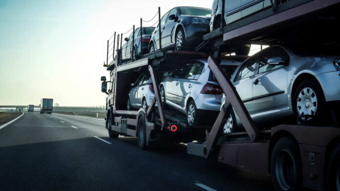 Car,Transporter,Trailer,Loaded,With,Many,Cars,On,A,Highway,