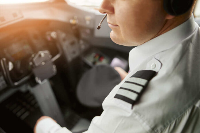 Male,Pilot,In,Cockpit,Of,Passenger,Airplane,Jet