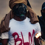BLM Activist FLIPS—Mass Incarceration Actually WORKS Protesters wearing masks and holding a flaming object
