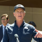 Disaster Looms: Familiar Faces Lead 2028 Democrats A man speaking at a press conference outdoors with a microphone