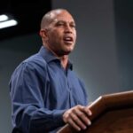 ICE Out of Control? Jeffries Sparks DHS Showdown A speaker delivering a presentation at a podium