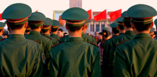 Soldiers in green uniforms standing in formation during a public event
