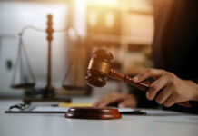 A gavel being struck on a desk in a courtroom setting