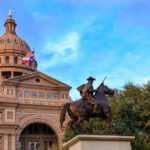 RINO Accusations Shake Texas Primary Statue of a rider in front of the Texas State Capitol building under a blue sky