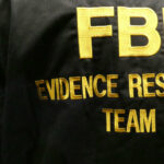 Immigration Fraud SCHEME — Fake Robberies Exposed Close-up of an FBI Evidence Response Team jacket with gold lettering