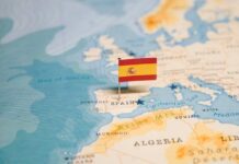 Map highlighting Spain with a small flag