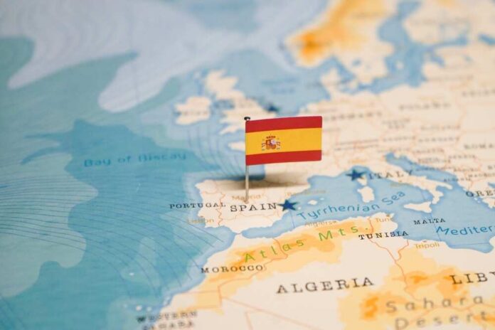 Map highlighting Spain with a small flag