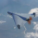 Massive Drone Assaults Shake Gulf Security A drone flying high above the clouds with a visible propeller