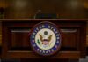 Podium with the United States Senate seal in a formal setting