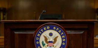 Podium with the United States Senate seal in a formal setting