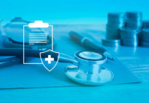 Stethoscope and insurance documents on a desk with coins in the background