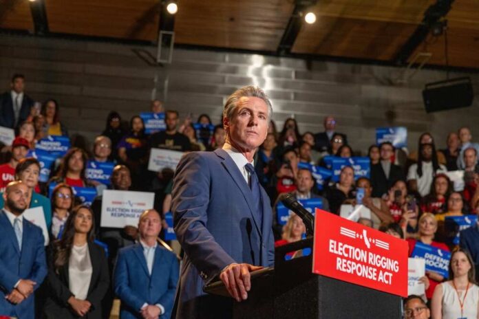 A speaker addressing a crowd at a political rally with signs in the background