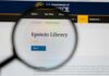 Magnifying glass focusing on the Epstein Library section of a government website