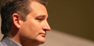 Profile view of a politician speaking into a microphone