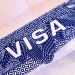 Close-up of a visa document showing the word VISA and intricate design elements