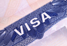 Close-up of a visa document showing the word VISA and intricate design elements