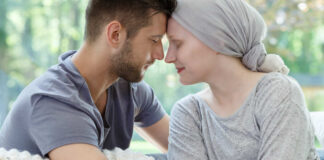 A couple sharing a tender moment, foreheads touching, in a cozy setting