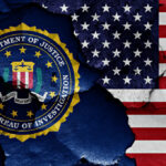 FBI emblem partially obscured by a cracked wall with an American flag background