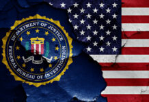 FBI emblem partially obscured by a cracked wall with an American flag background
