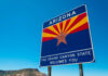 Welcome sign for Arizona with a blue sky background