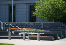 Massive Reform — Colorado Ends False Arrests Exterior view of the Colorado Supreme Court building with landscaped flowers