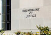 Sign on the exterior wall of the Department of Justice building