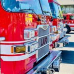 Close-up of red fire trucks parked in a row