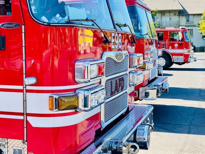 Close-up of red fire trucks parked in a row