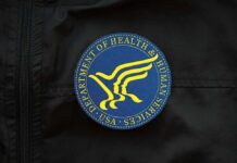 Close-up of a blue and yellow emblem of the Department of Health and Human Services