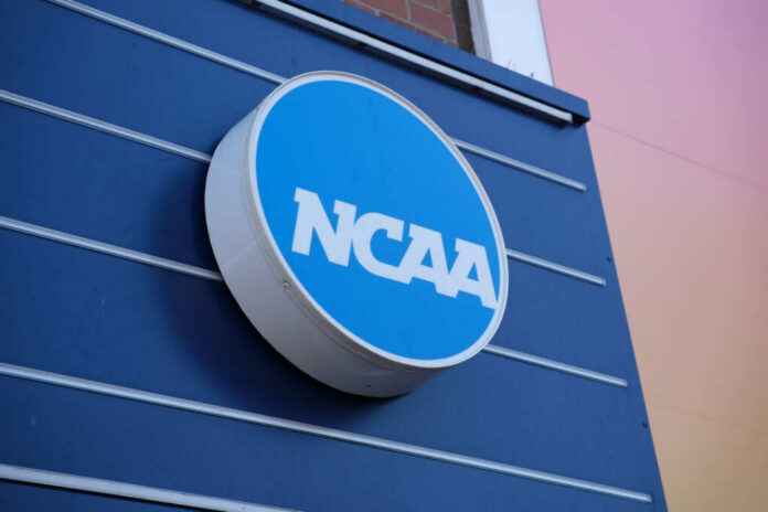 shutterstock_2484566289.jpg NCAA logo displayed on a blue wall