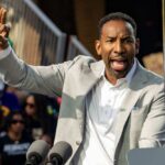Atlanta’s Suburbs Rocked by Predawn Terror A speaker passionately addressing a crowd at an outdoor event