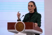 A female politician delivering a speech at a podium