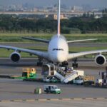 Large airplane at an airport with ground service vehicles