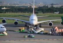 Large airplane at an airport with ground service vehicles