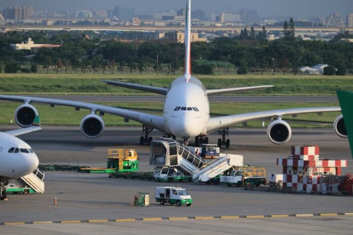 Large airplane at an airport with ground service vehicles