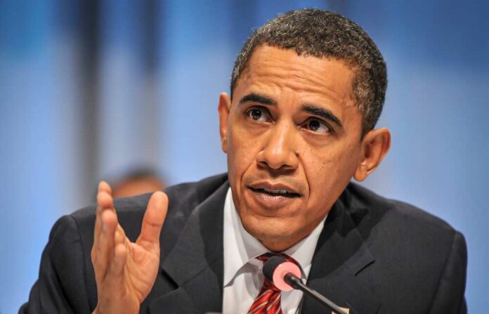 A man speaking passionately at a conference with a microphone in front of him