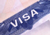 Close-up of a visa document showing the word VISA and intricate design elements