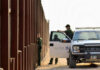 U.S. Customs and Border Protection officers near a border fence