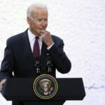 Biden’s Shocking Memory Lapses Exposed! A man in a suit speaking at a podium with a presidential seal