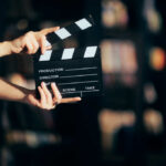 Hands holding a film clapperboard ready for a scene take
