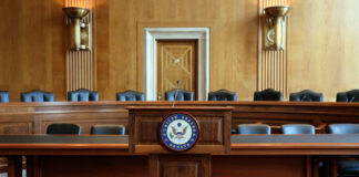 Wooden podium with the United States Senate seal in an empty Senate chamber