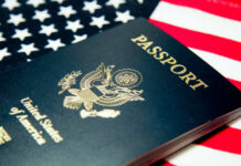 An American passport resting on a background of the USA flag