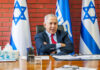 Netanyahu’s Shocking Break From U.S. Aid—Why Now? A political leader seated at a desk with Israeli flags in the background