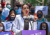 A speaker passionately addressing a crowd at a political rally