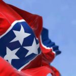 Tennessee state flag waving against a blue sky